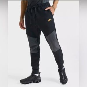 Nike Men’s Black Joggers with Gray Knee Panels and Gold Swoosh
